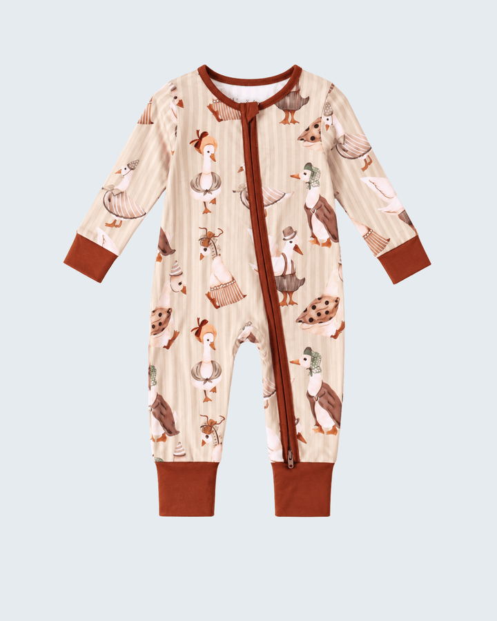 Animal-print onesie romper with long sleeves, brown zipper, and matching cuffs