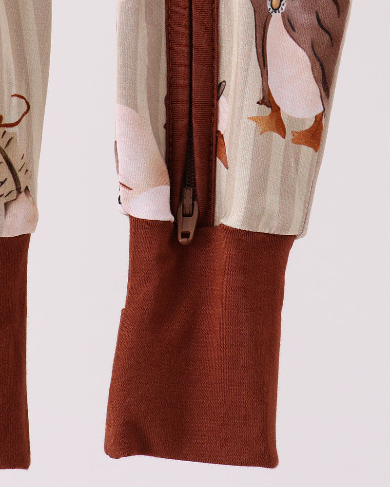 Long-sleeve animal-print romper with brown front zipper and cuffed legs