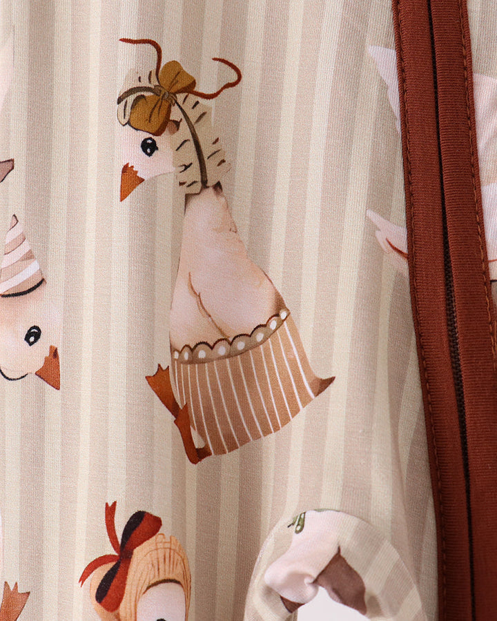 Animal-print romper close-up with brown zipper tape and stitched detailing