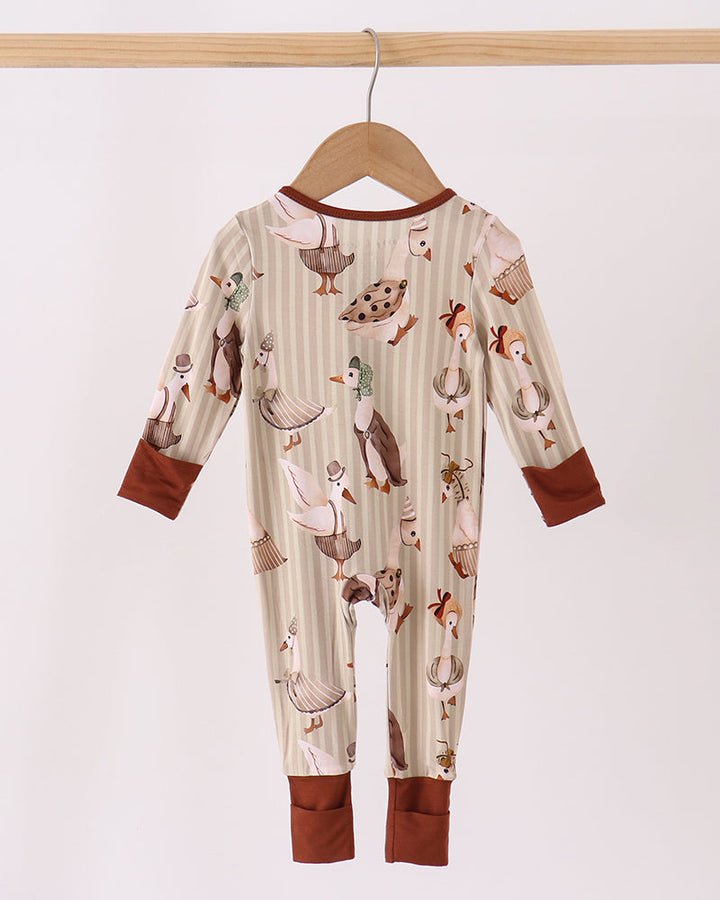 Animal-print long-sleeve romper with brown zipper and matching cuffed ankles