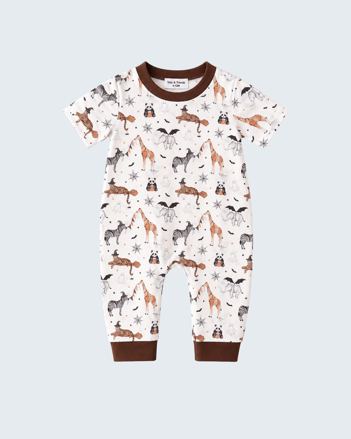 A baby short-sleeve footless jumpsuit with an all-over woodland animal print on an off-white background, featuring brown ribbed trim at the crew neck, sleeve cuffs, and ankle cuffs.