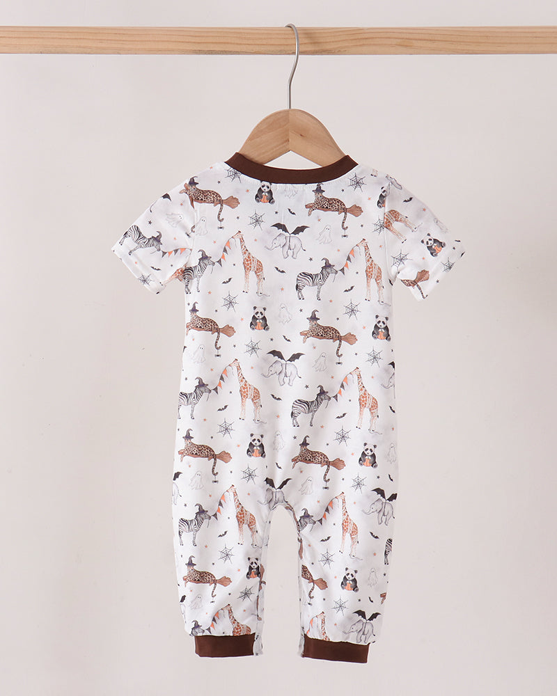 A baby short-sleeve footless romper hanging on a wooden hanger from a wooden rod. The romper has an all-over print of brown and black dogs on a white background, with dark brown ribbed trim at the collar and cuffs.