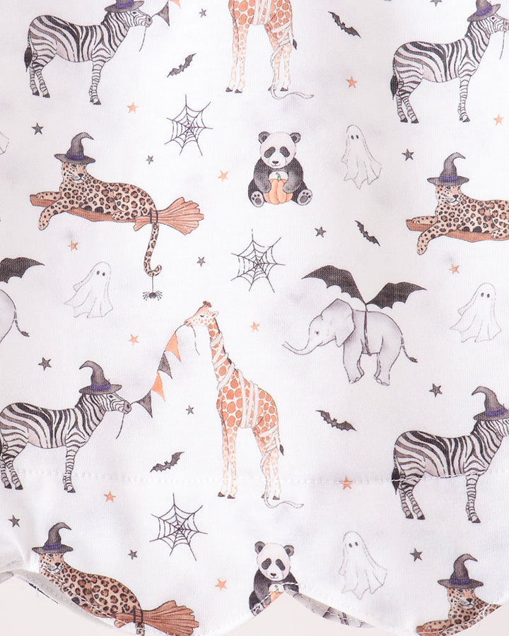 White fabric with a whimsical Halloween print featuring zebra, giraffe, leopard, elephant, panda, ghost, spiderweb, bat, and witch hat motifs.