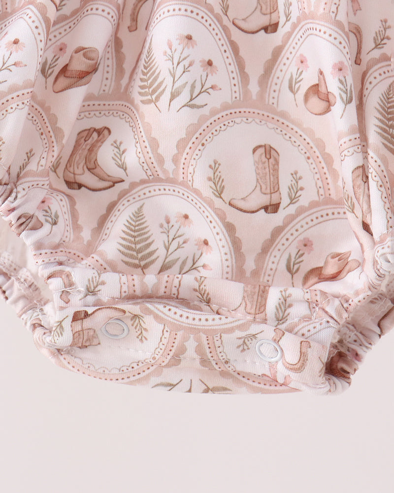 Cream patterned bubble romper with elastic ruffle hem and long sleeves, no text