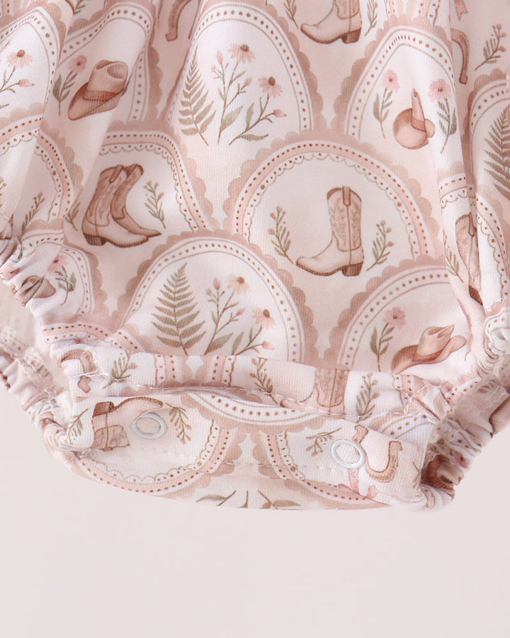 Cream patterned bubble romper with elastic ruffle hem and long sleeves, no text