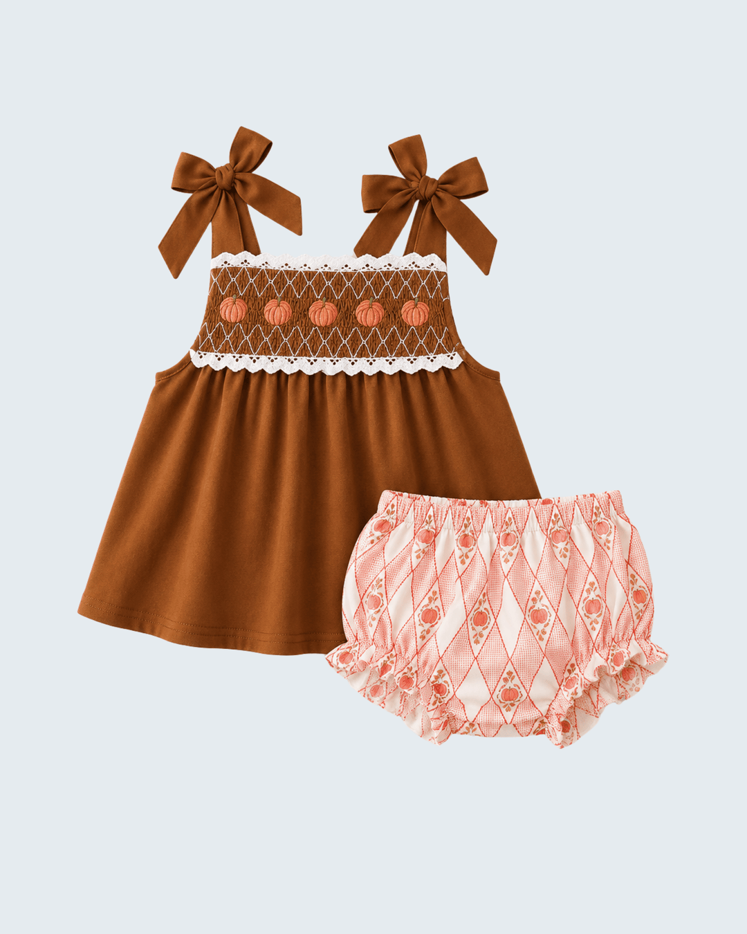 Brown smocked lace dress with white ruffle trim and pink patterned bloomer with bows