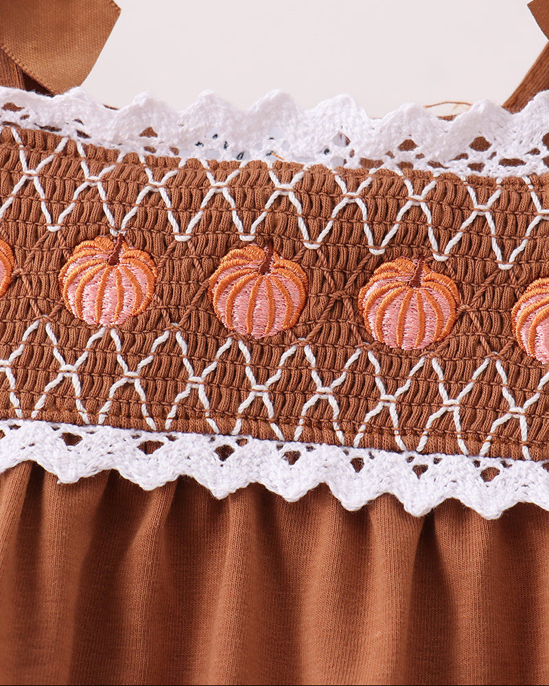 Smocked brown bloomer with orange pumpkin buttons and white lace edging