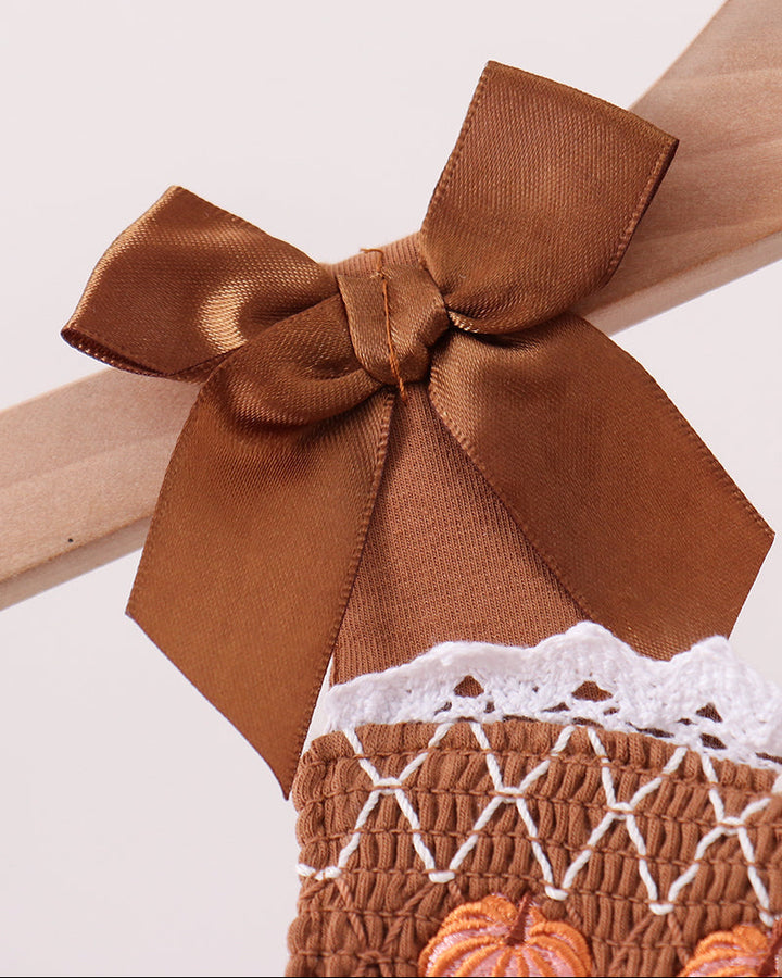 Brown dress bow straps with lace-trimmed smocked bloomer detail