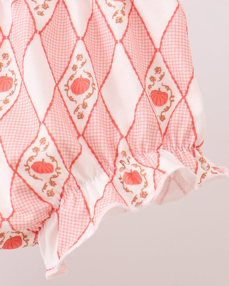 Peach and coral patterned bloomer with smocked waistband and ruffled lace trim