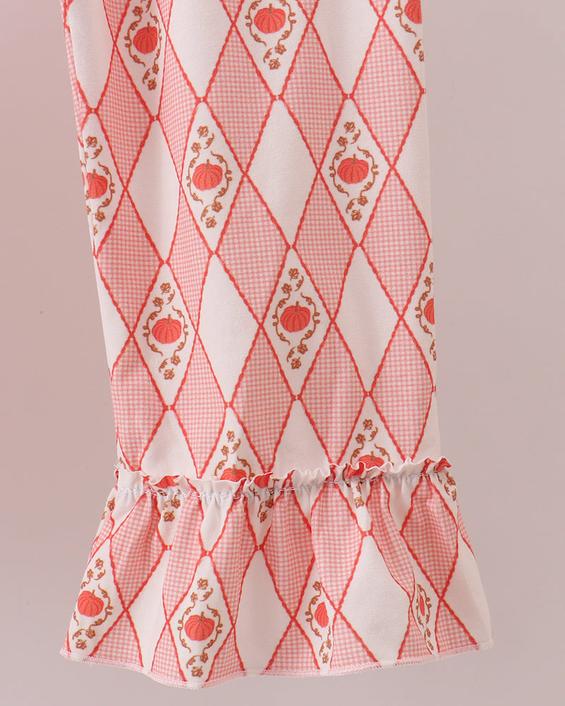 Red/orange diamond print pants with smocked waistband and ruffled hem