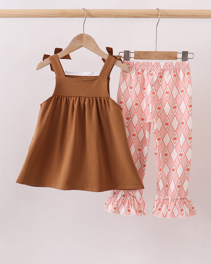 Brown sleeveless dress with smocked yoke and white lace; matching red diamond pants