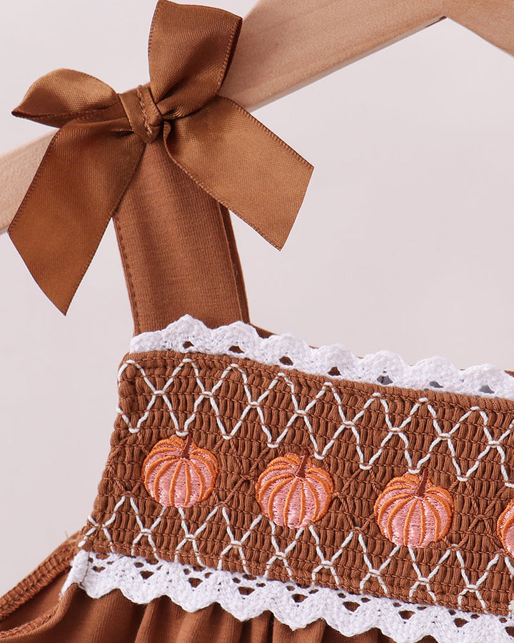 Brown smocked waistband with pumpkin embroidery and white lace trim