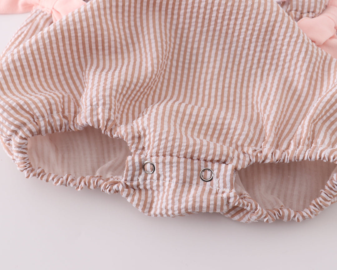 Striped baby romper with pink accents on a white background