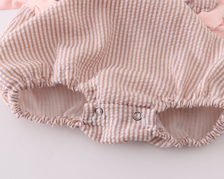 Striped baby romper with pink accents on a white background