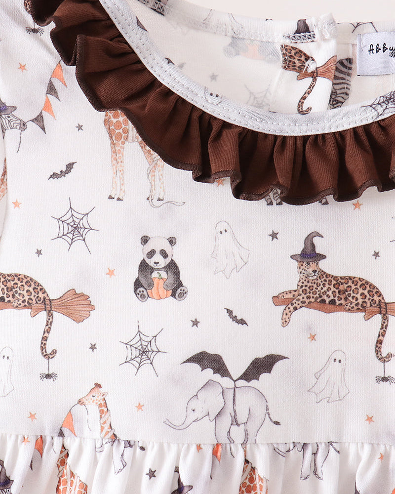 A close-up of a baby dress featuring a white base with a whimsical Halloween print of pandas, leopards, ghosts, and bats, accented by a dark brown ruffled collar and hem.