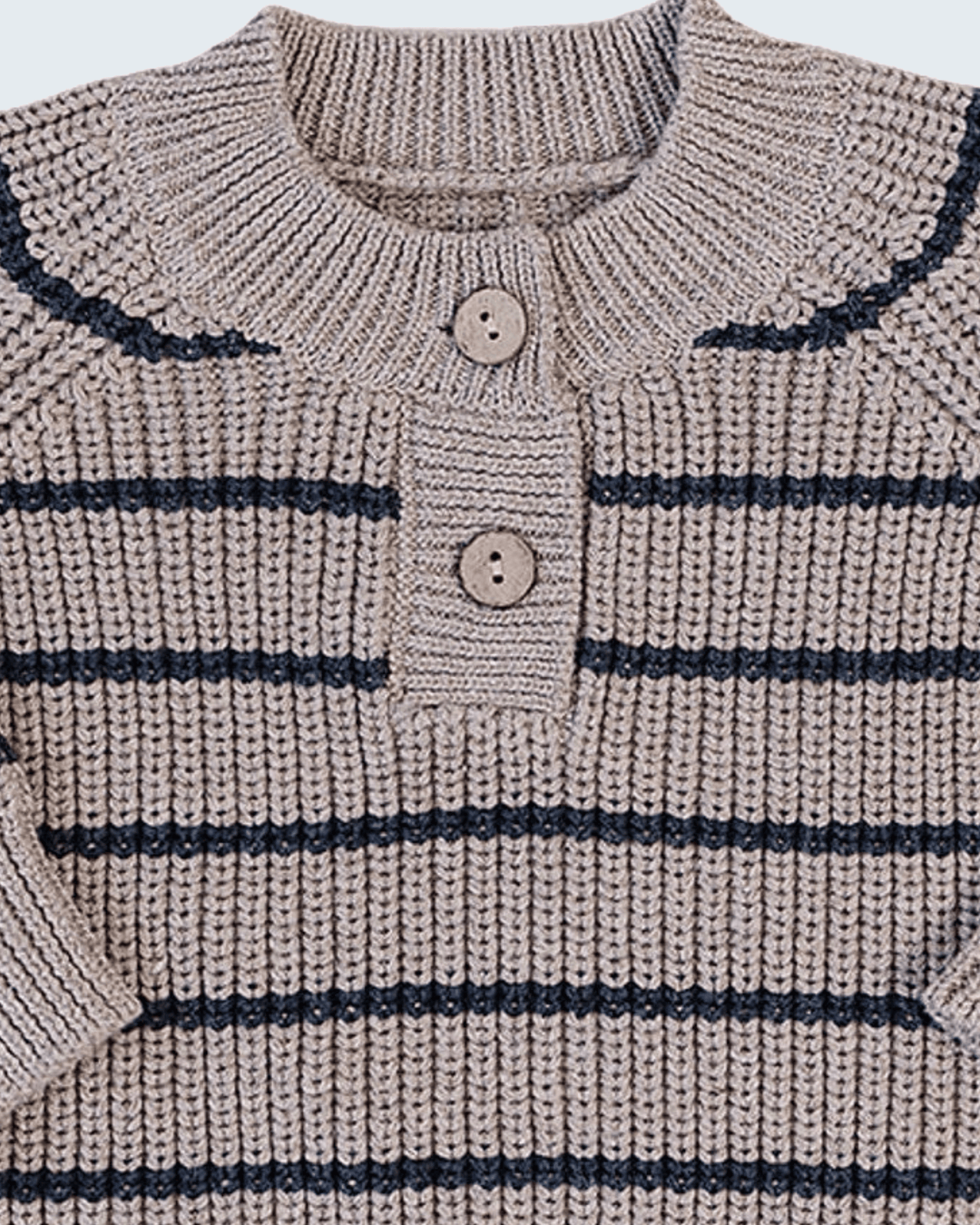 Close-up of a ribbed knit sweater with horizontal navy stripes on a warm beige base, featuring a buttoned henley neckline with two wooden buttons.
