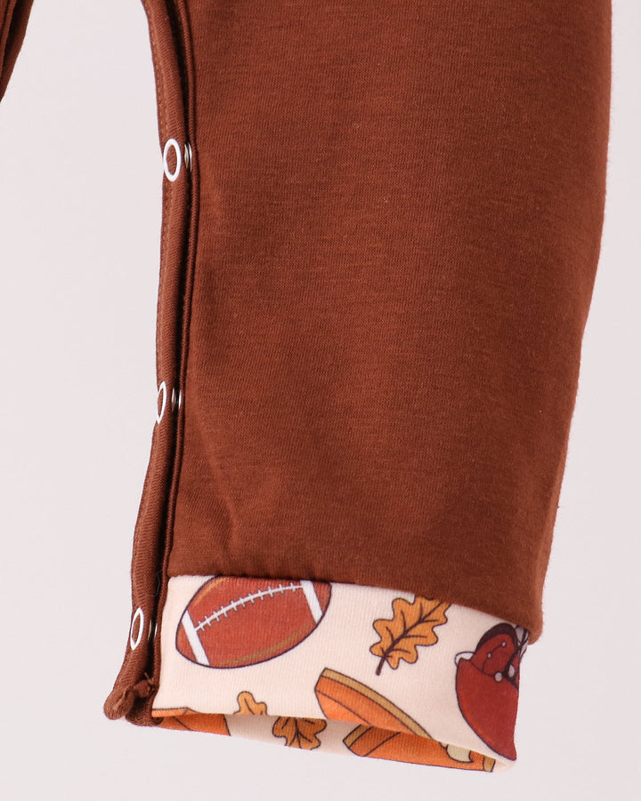 Brown romper leg with football-printed cuff detail at hem