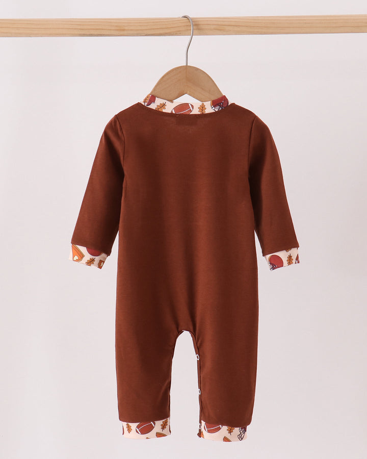 Brown long-sleeve baby romper with front button placket and printed cuffs