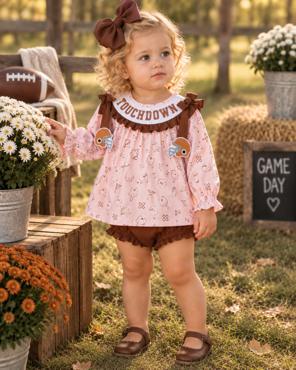 Toddler football bloomer set, pink patterned long-sleeve with brown ruffle collar and bloomer