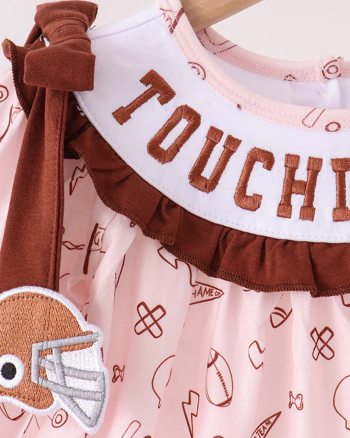 Pink top with brown ruffle trim and touchdown-style embroidery