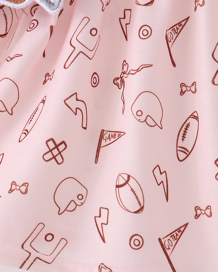 Pink top with all-over football and sports icon print