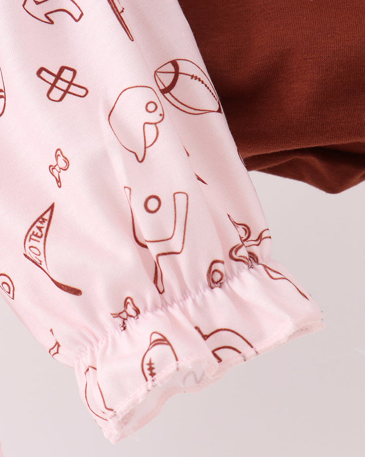 Pink football-print top with brown accents and gathered elastic hem