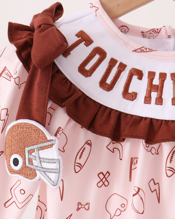 Toddler bubble romper close-up: brown ruffle bib with “TOUCHDOWN” embroidery and icons