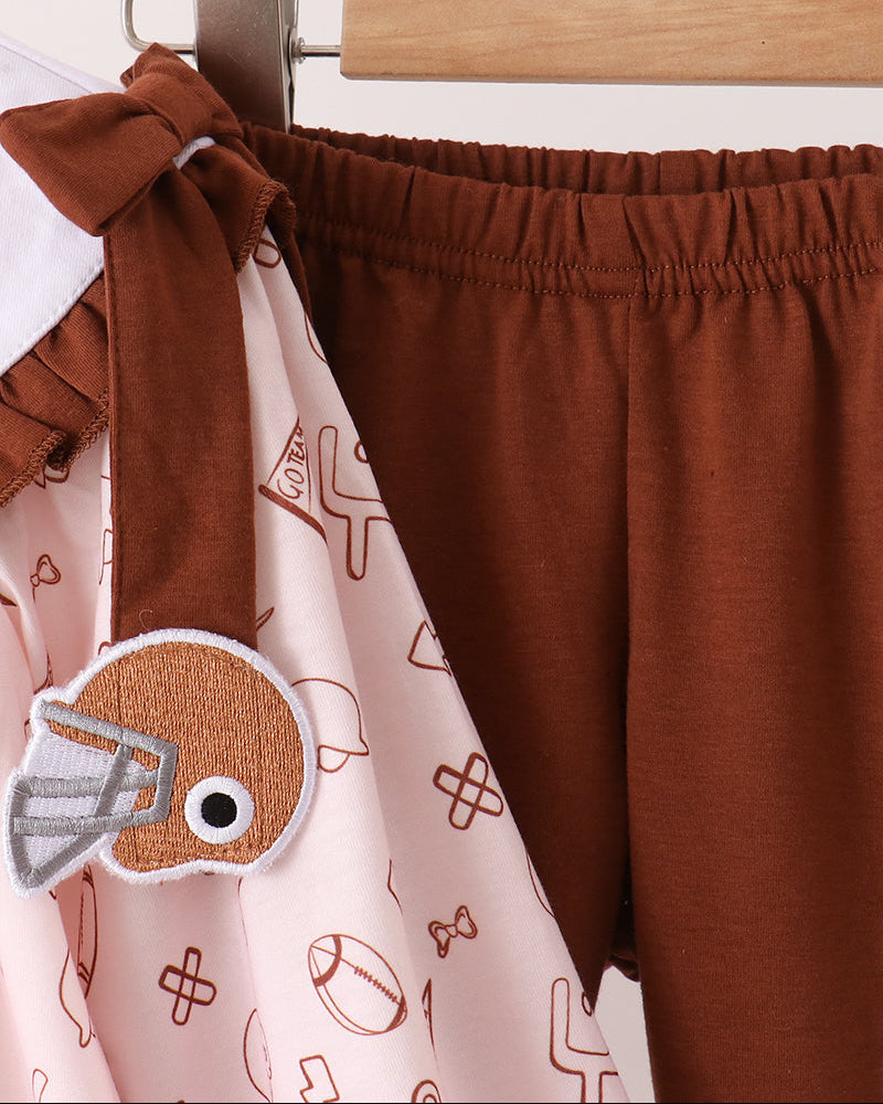 Dark brown pants with elastic waistband and side bow, paired with printed top