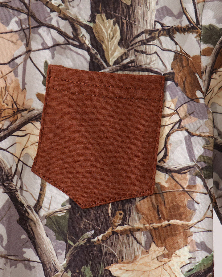 Tree-print romper chest pocket in brown fabric with stitched edges