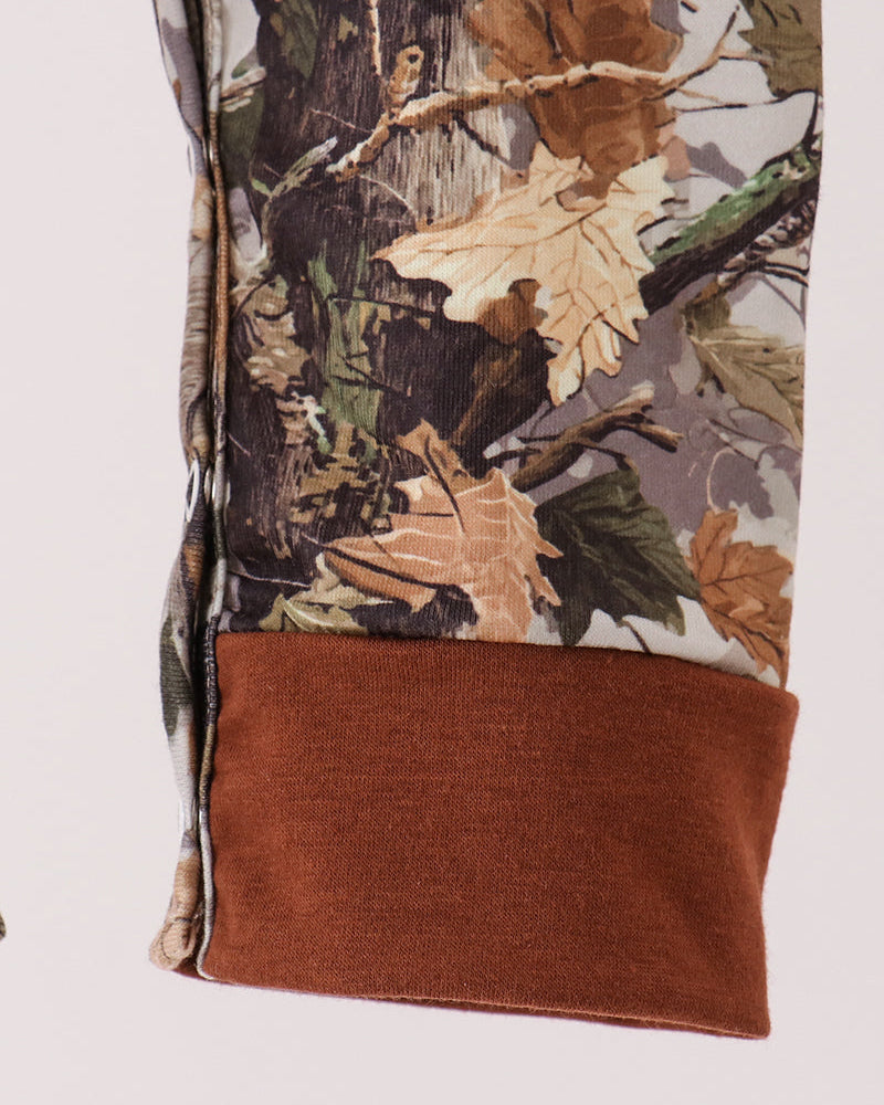 Tree-print romper with front pocket detail and brown cuffs
