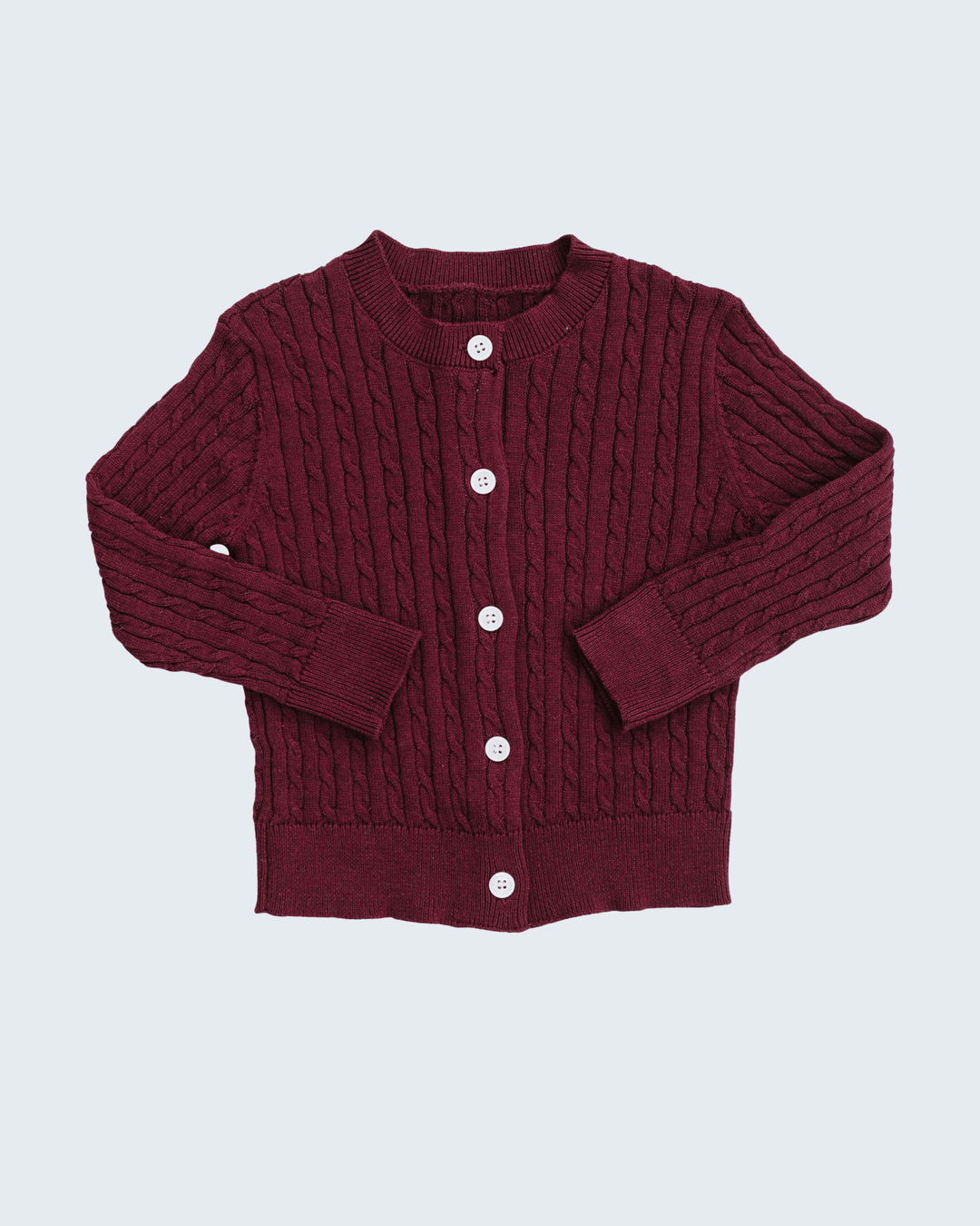 A burgundy cable-knit cardigan sweater with white buttons, laid flat against a light gray background.