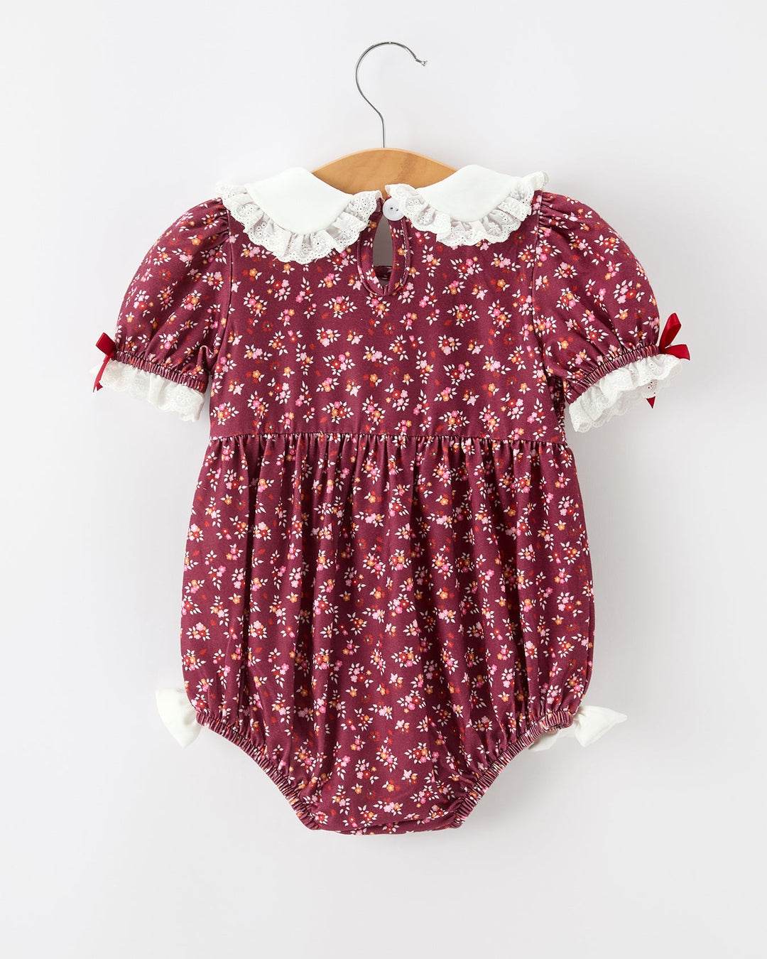 Burgundy floral bubble romper for baby girl with white Peter Pan collar and ruffled sleeves