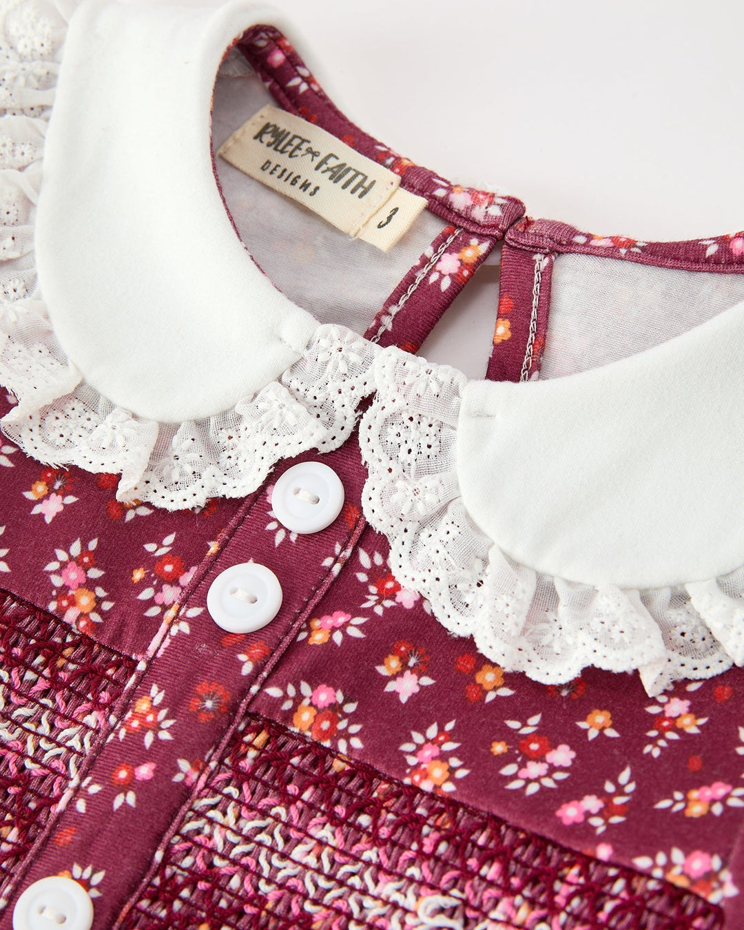 Close-up burgundy floral dress with white peter pan lace collar and button front