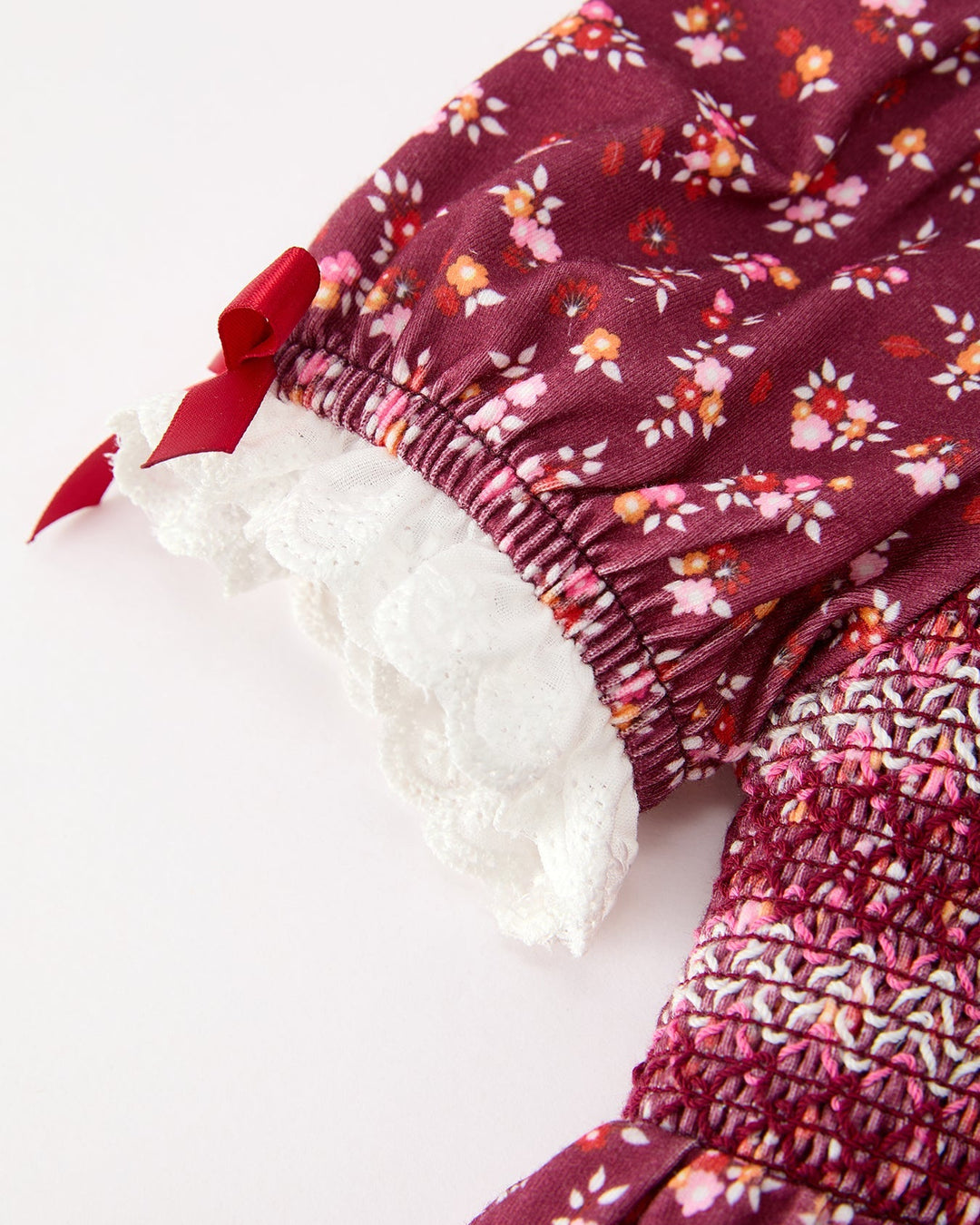 Burgundy floral dress sleeve with lace cuff and ruched smocked waist detail