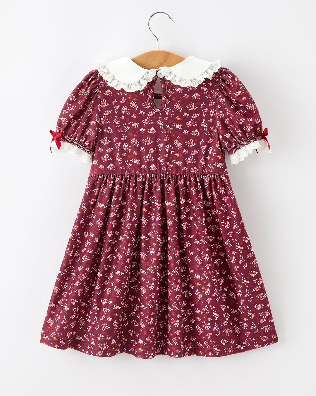 Burgundy floral girls smocked dress with peter pan collar and lace-trimmed puff sleeves