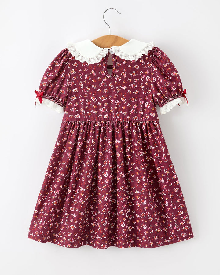 Burgundy floral girls smocked dress with peter pan collar and lace-trimmed puff sleeves