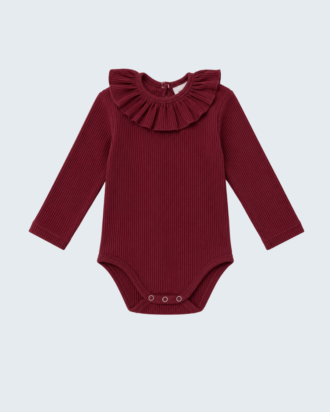 A long-sleeve ribbed baby bodysuit in deep burgundy, featuring a large ruffled collar and snap closures at the crotch, shown against a light gray background.