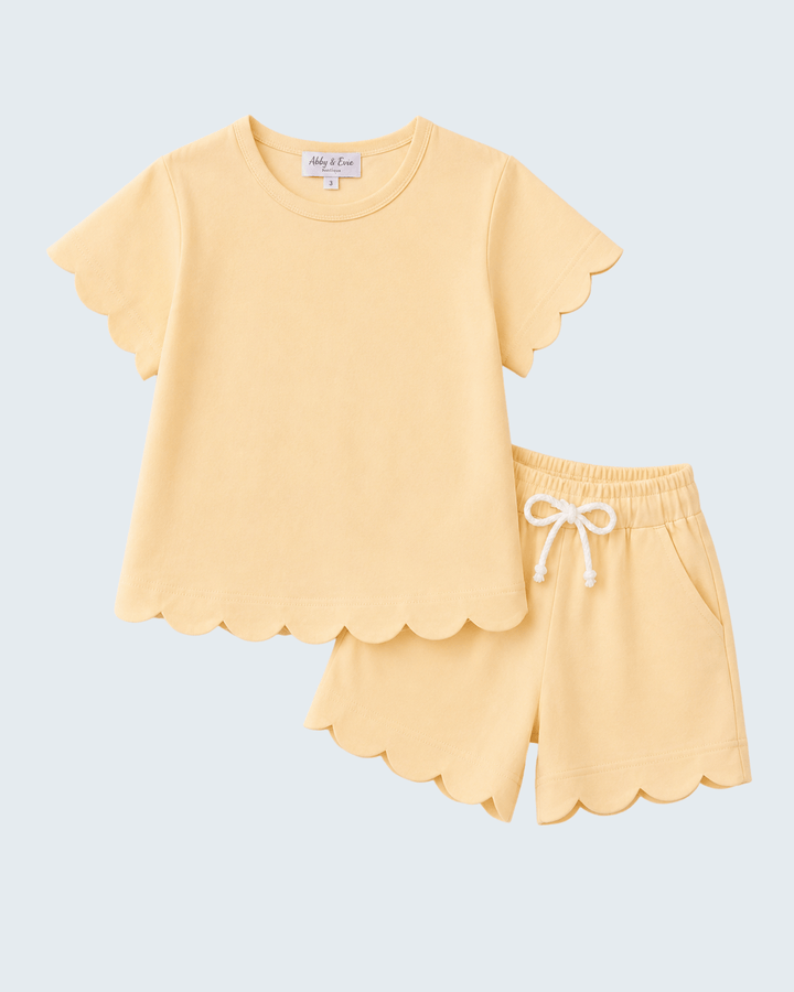 Yellow shorts set with scalloped edges on a light blue background
