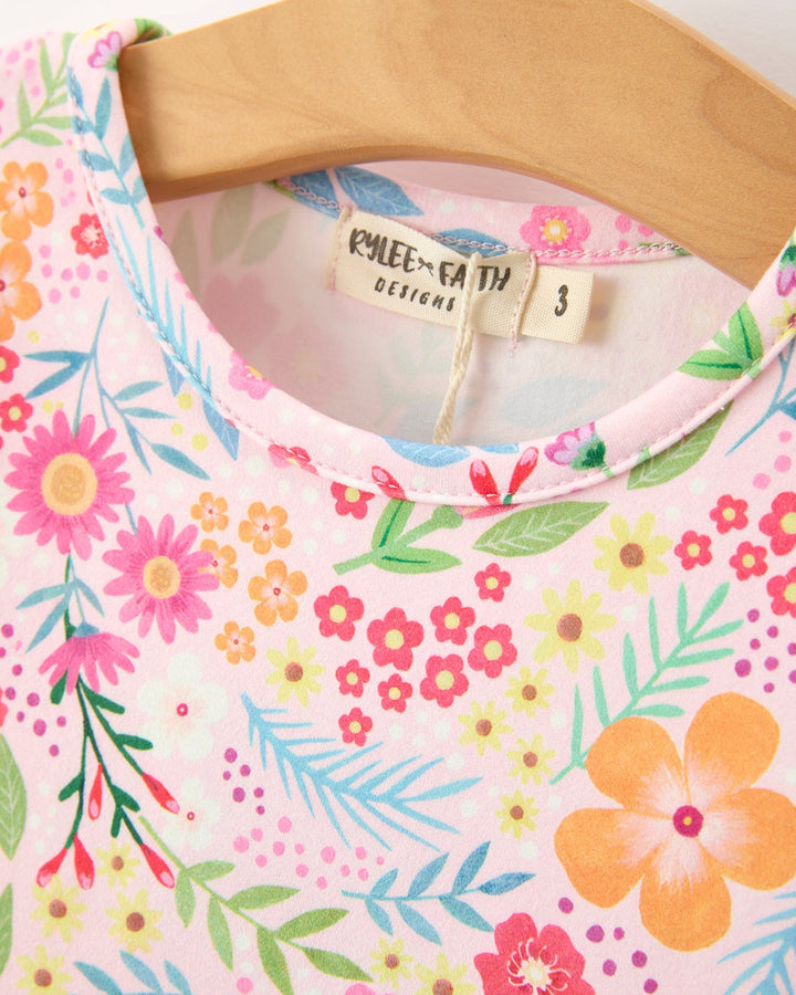 Floral-patterned garment on a hanger with a visible brand tag.
