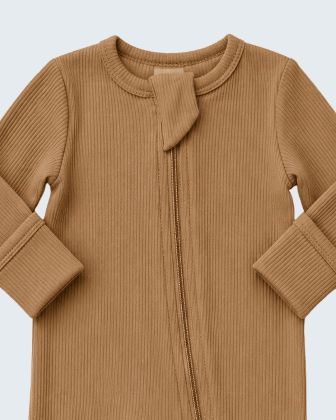 A close-up of a long-sleeve ribbed knit baby romper in a warm camel brown color, featuring a front zipper and a decorative tie detail at the neckline.