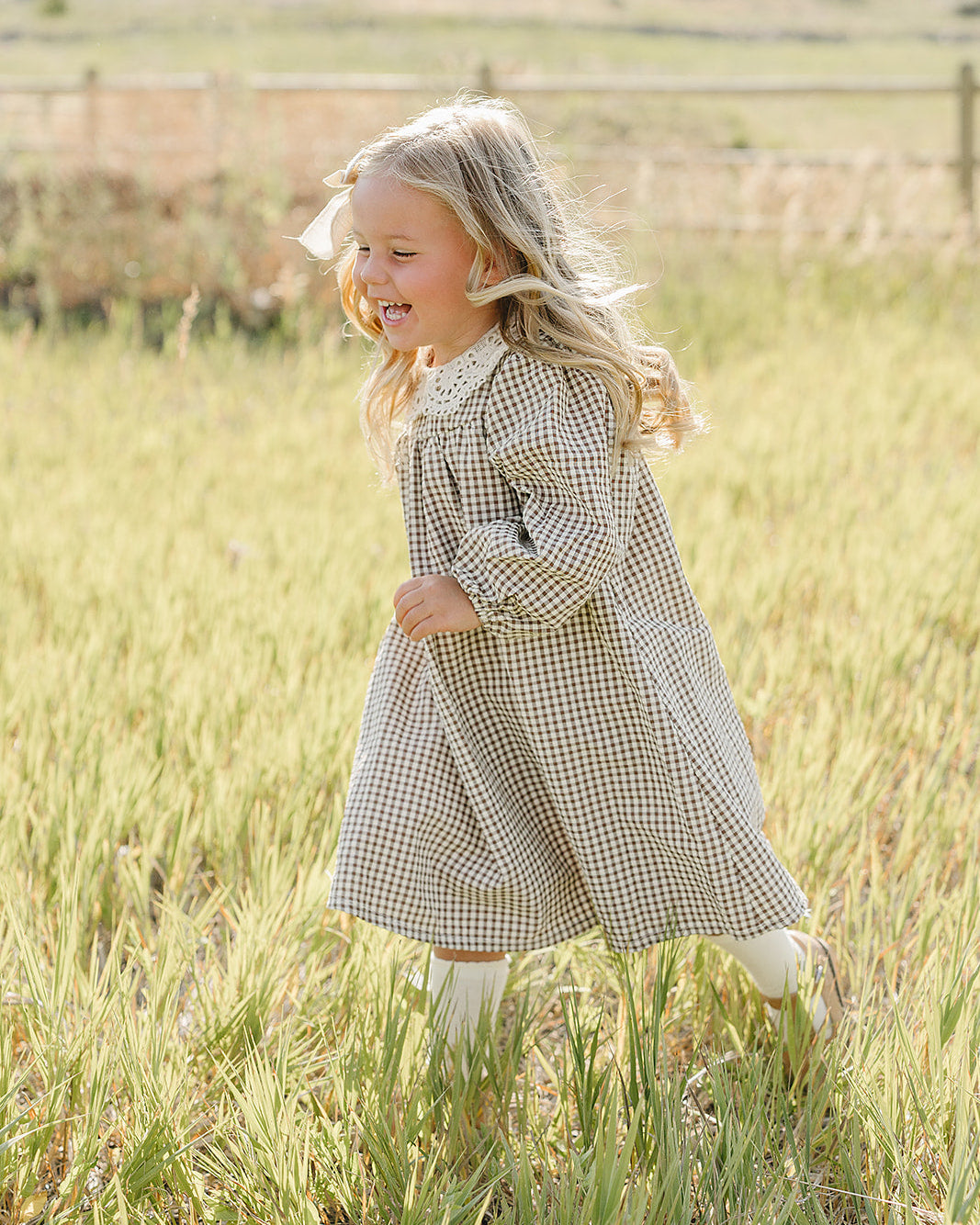 Gingham lace dress worn by child, long sleeves and lace-trim collar