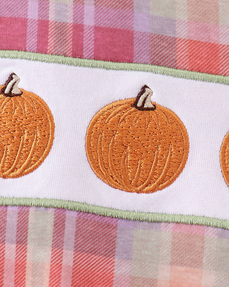 Plaid romper with orange embroidered pumpkins and green-stitched trim