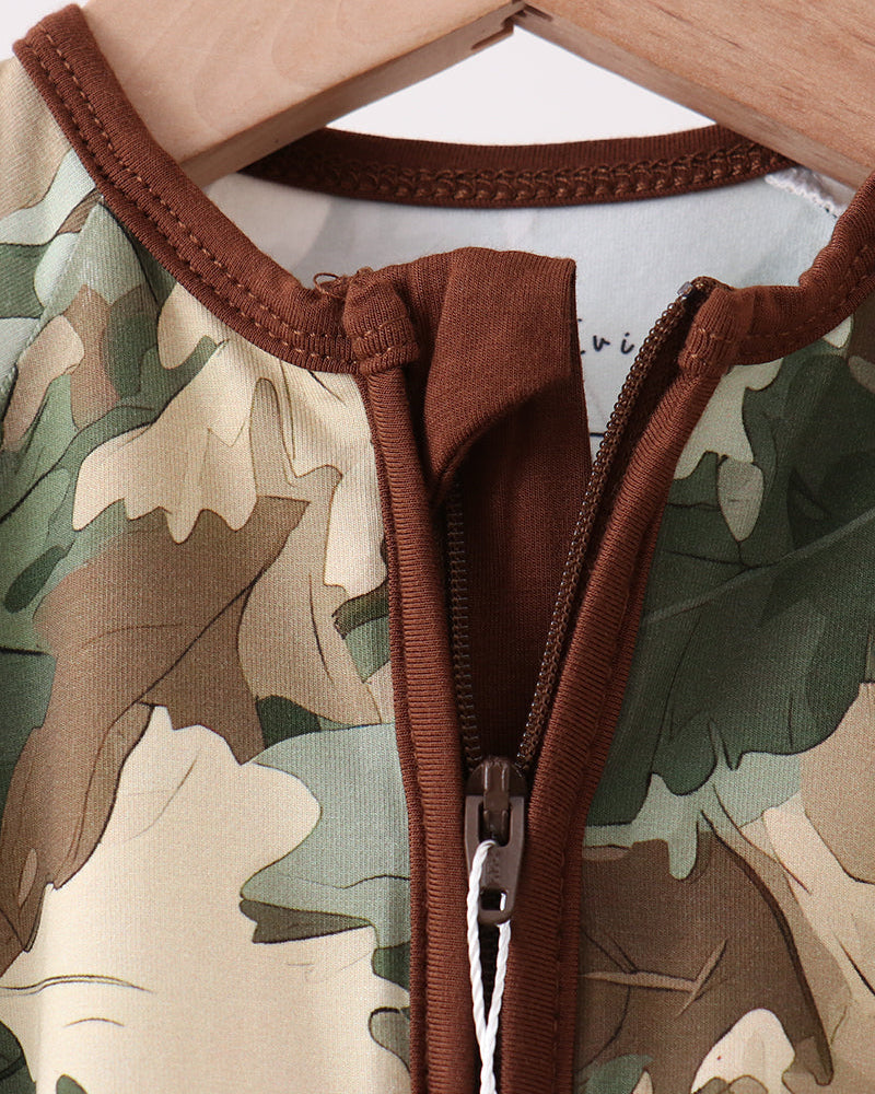 Camouflage romper with brown zipper and trim on a white background