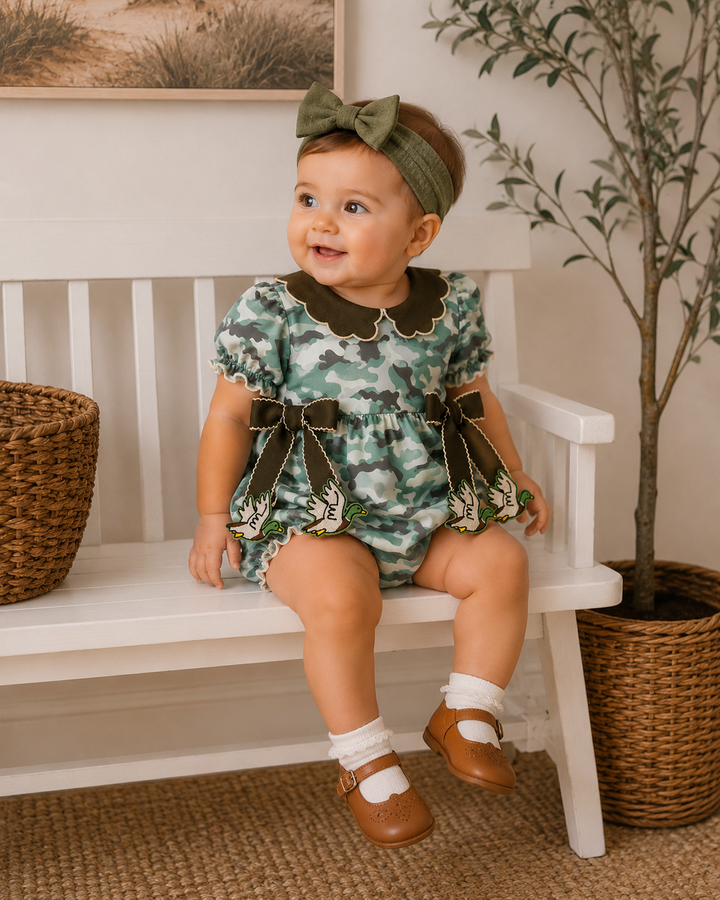 Camouflage ruffle bubble romper on baby, scalloped neckline with bow-tie side details