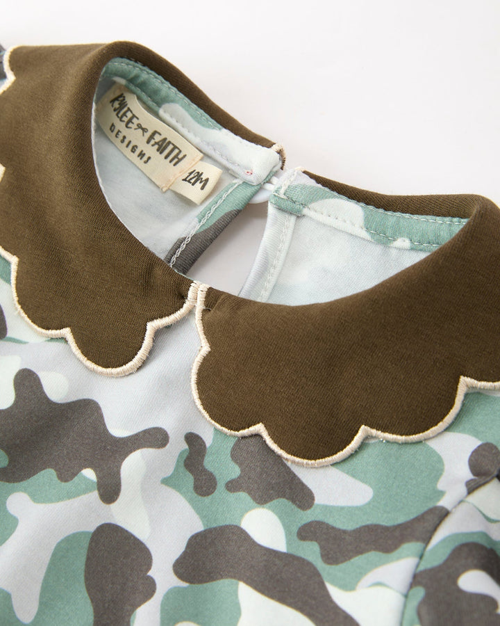 Brown scalloped neckline with camouflage print; inner tag visible at collar