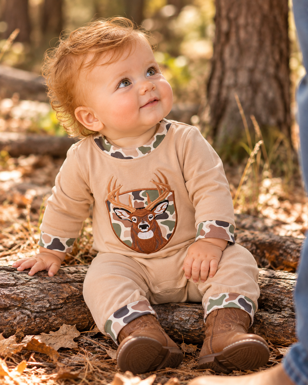 Baby boy is wearing a Camo Deer Appliqué Baby Boy Romper