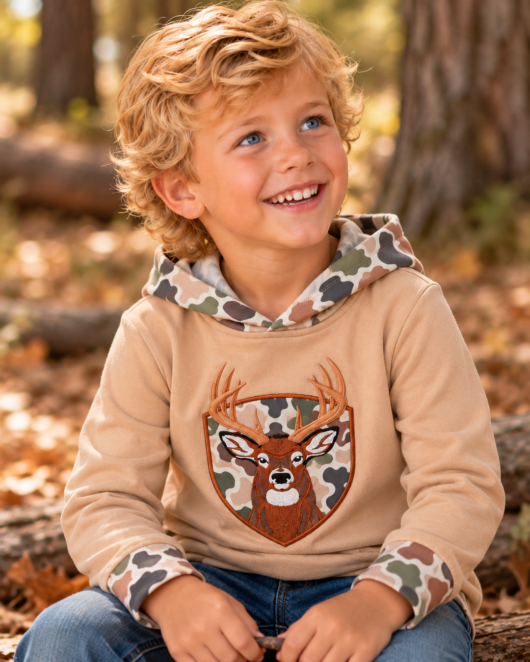 Young boy is wearing a Camo Deer Appliqué Hoodie