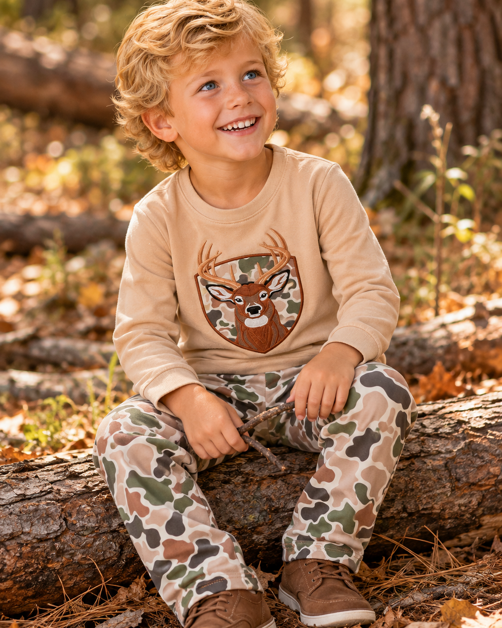 Young boy is wearing a Camo Deer Appliqué Pants Set