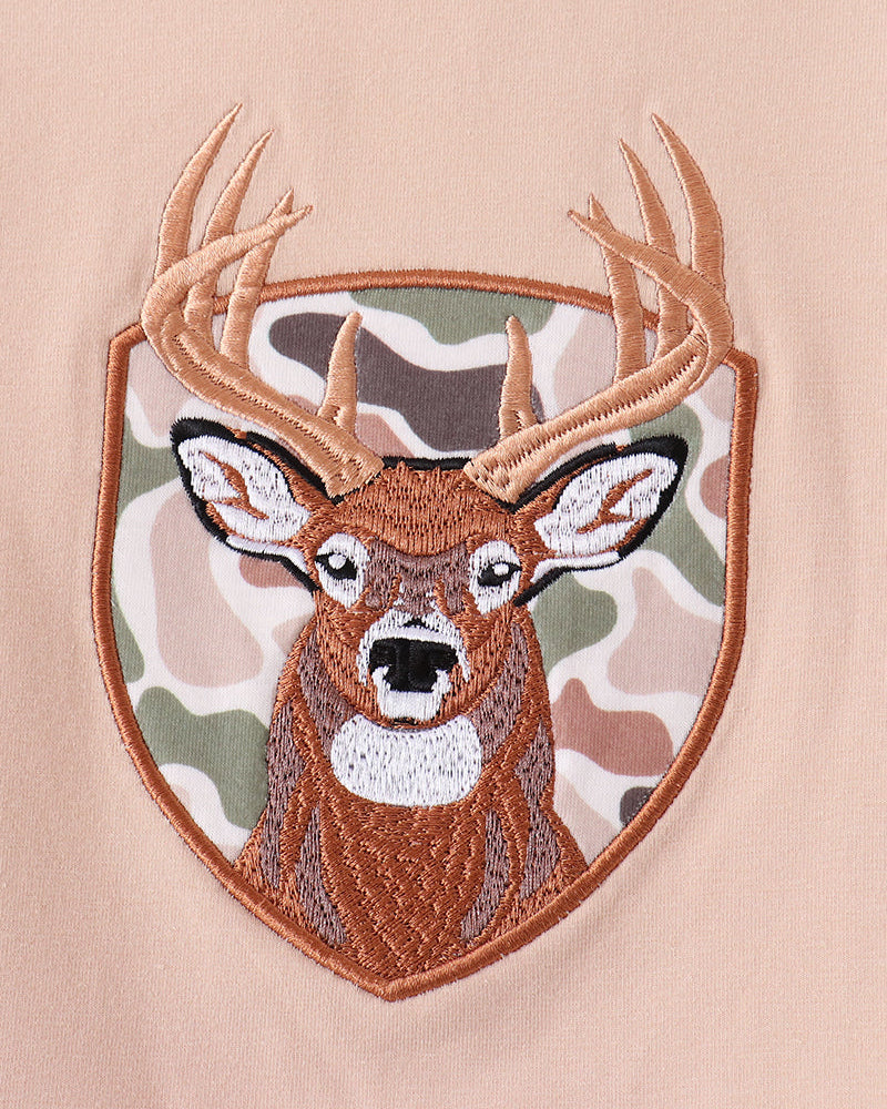 Deer face applique on beige long-sleeve top with embroidered border
