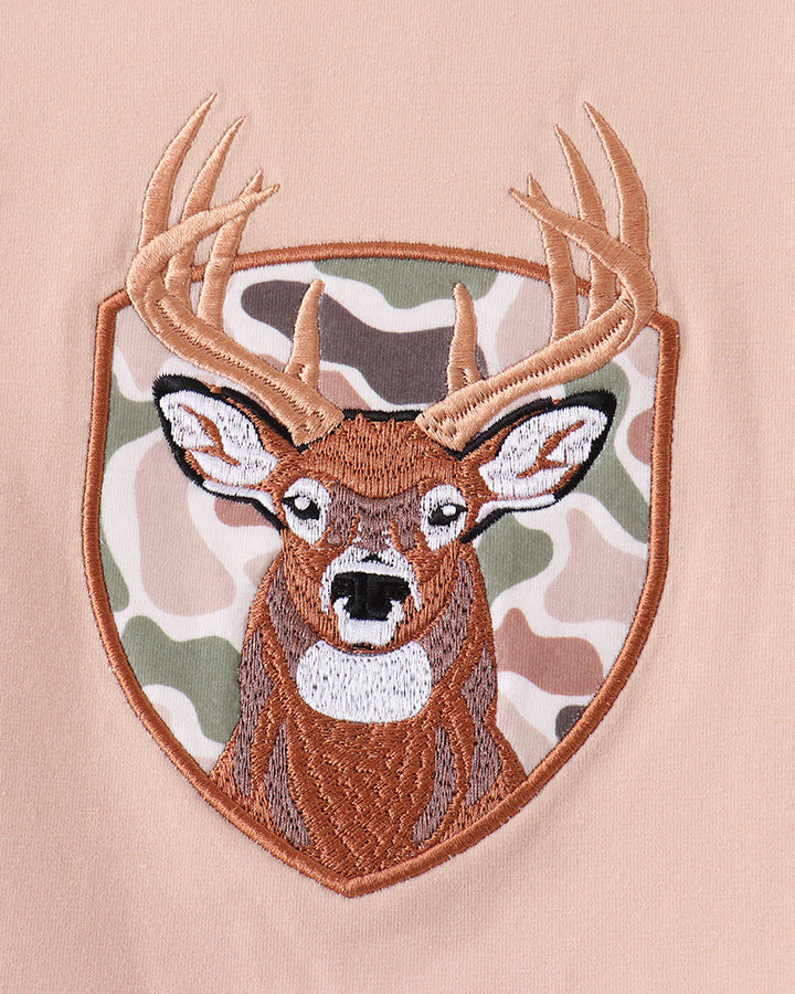 Deer face applique on beige long-sleeve top with embroidered border